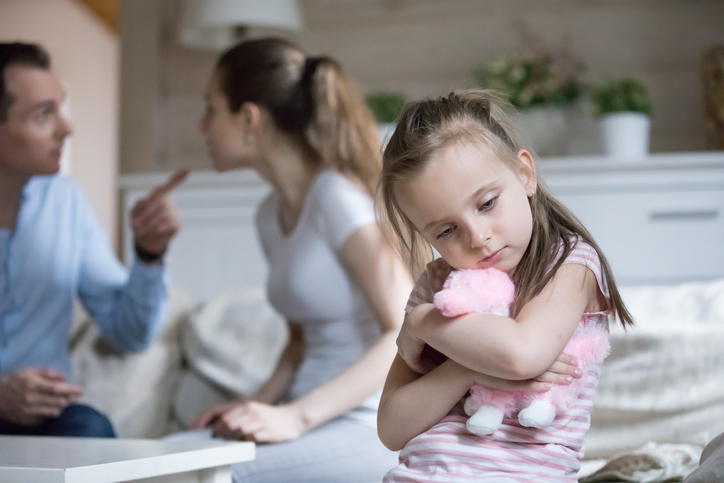 Elderly man holding his granddaughter