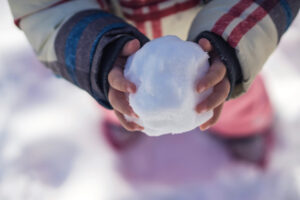 Snowball in childs hands
